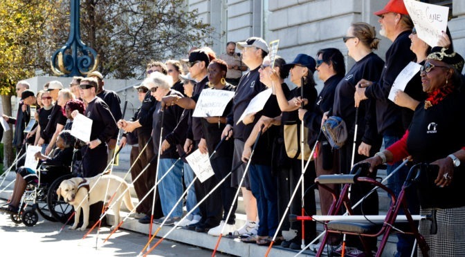 A group of LightHouse staff and community members promoting the Safe Streets project