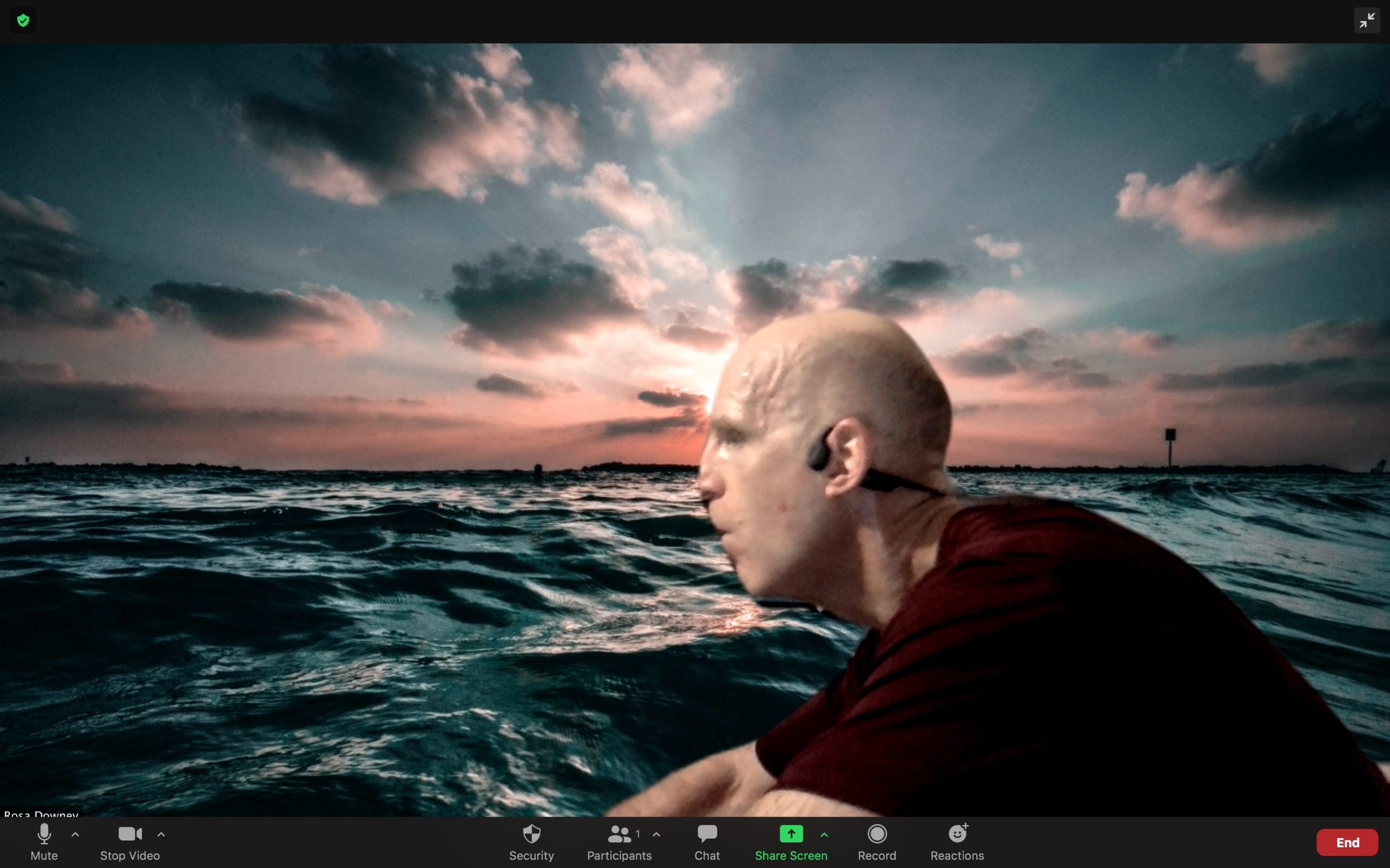 A Zoom image of Chris rowing with the English Channel as a virtual background