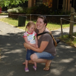 Family Camp Photos A women holds a young child outdoors
