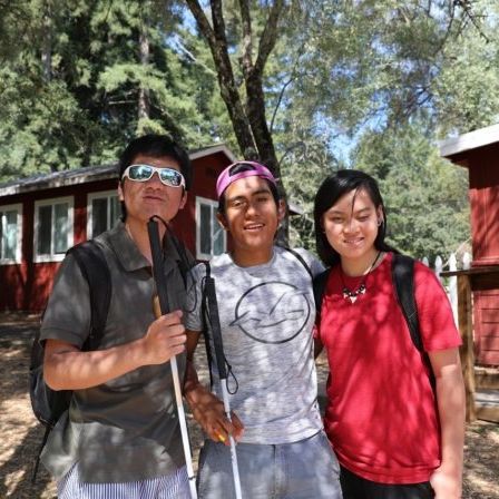 EHC Teens Teens pose in front of the cabins at EHC
