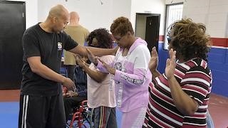 George Freeman demonstrates how to position arms at a Personal Safety Workshop