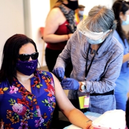 fb9becd4-de72-483d-9500-c946654309b0 A nurse preps a person to receive a COVID-19 shot at LightHouse in 2021