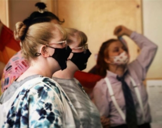 Teens wearing masks gather in the Kiva at EHC