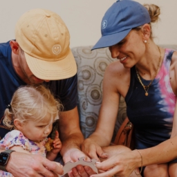 ¬Little Learners Mom Amanda and Dad Hunter 3 featured image Hunter, Amanda and Little Learner sit on a couch