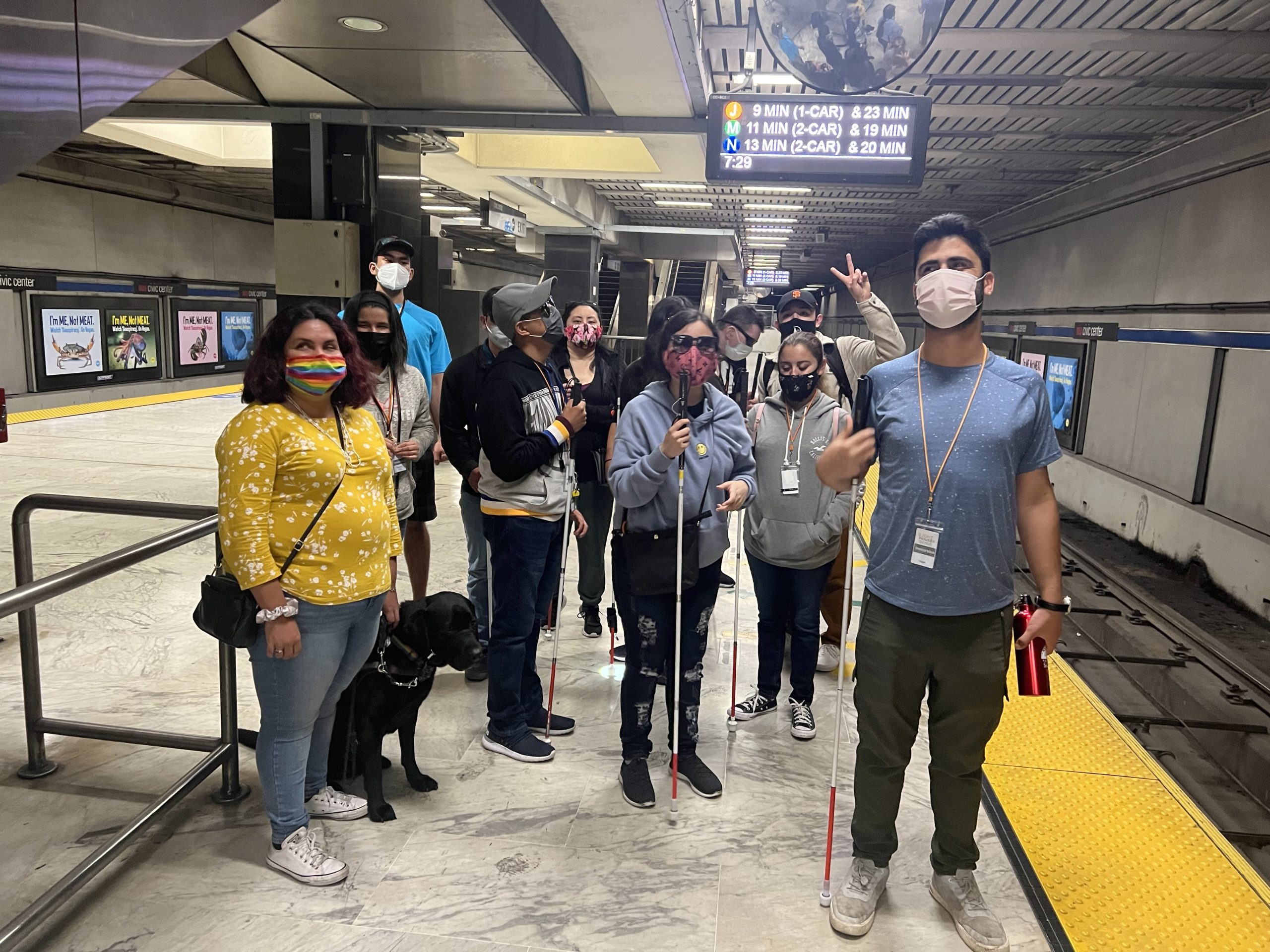 LightHouse staff and students stand on a BART platform