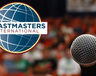 A microphone coupled with the Toastmasters logo, a stylized globe with the words “Toastmasters International” over it