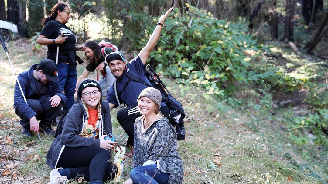 A group of teenage campers pose together on a hiking trail at Enchanted Hills Camp