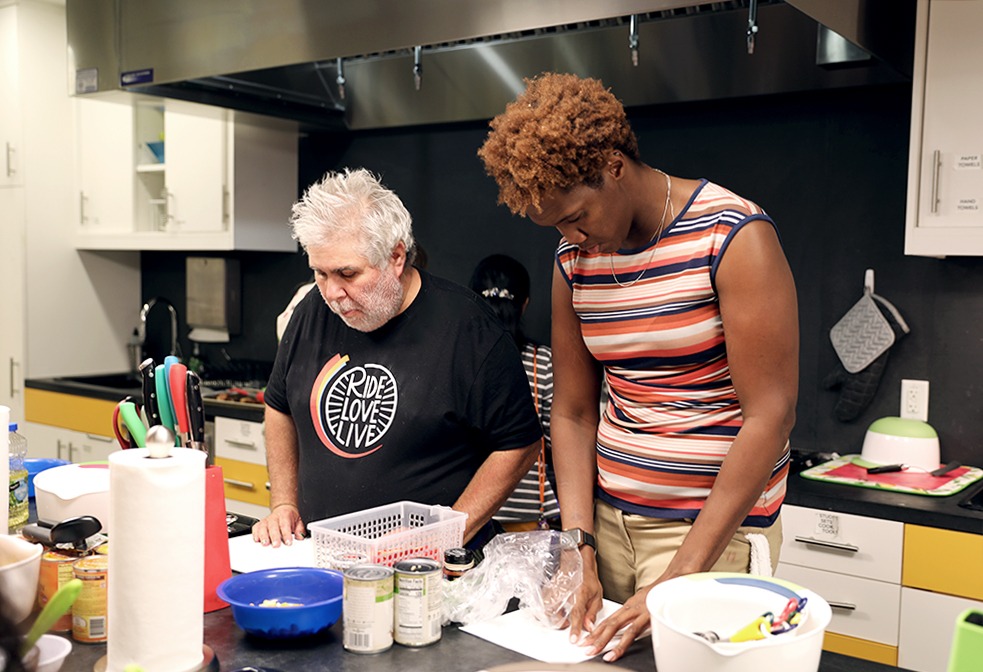 Bobbi Pompey, right, works in the LightHouse Training Kitchen with a student