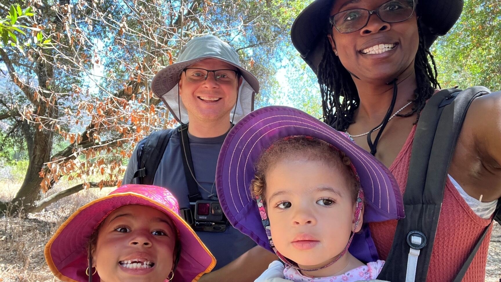 Little Learner Casey, Little Learner Mom Latasha and family smile while wearing sunhats in various colors