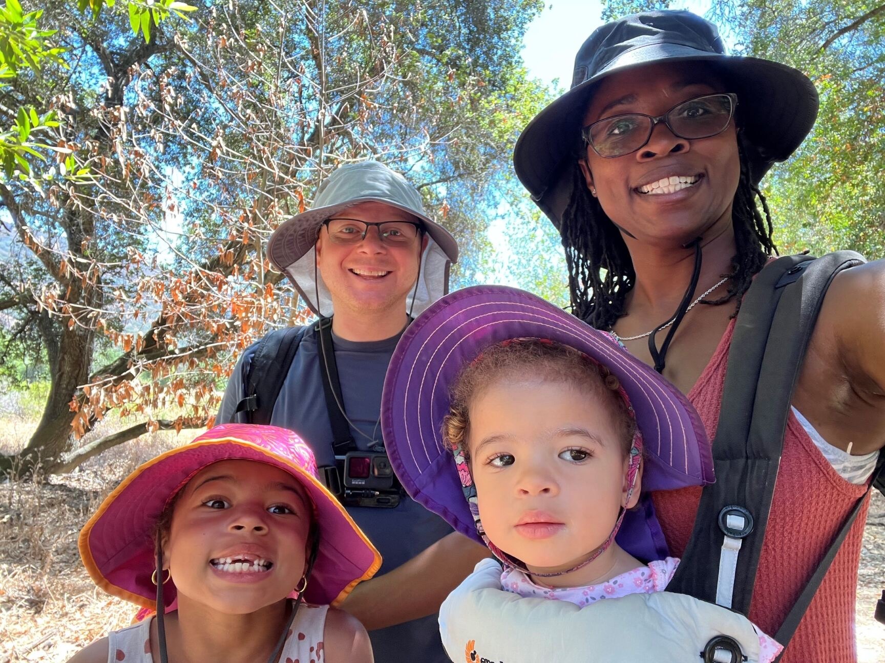 Little Learner Casey, Little Learner Mom Latasha and family smile while wearing sunhats in various colors