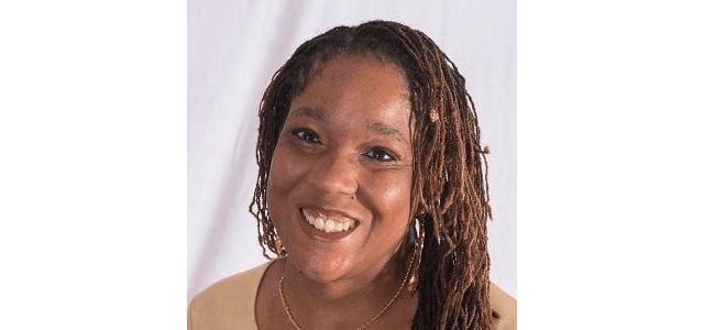 Kari Kelly, a black woman with thin braids in her hair