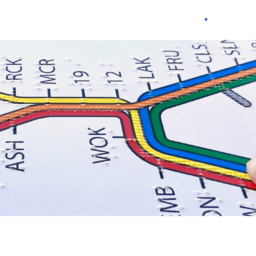 A finger explores a tactile BART system map.