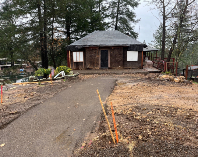 EHC Gathering House Restoration of the Gathering House, a single-story structure surrounded by trees and greenery