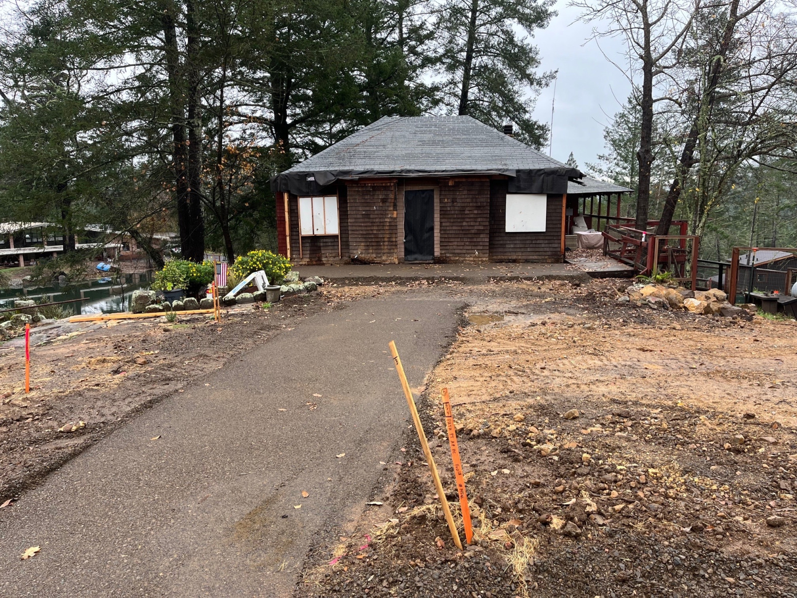 EHC Gathering House Restoration of the Gathering House, a single-story structure surrounded by trees and greenery