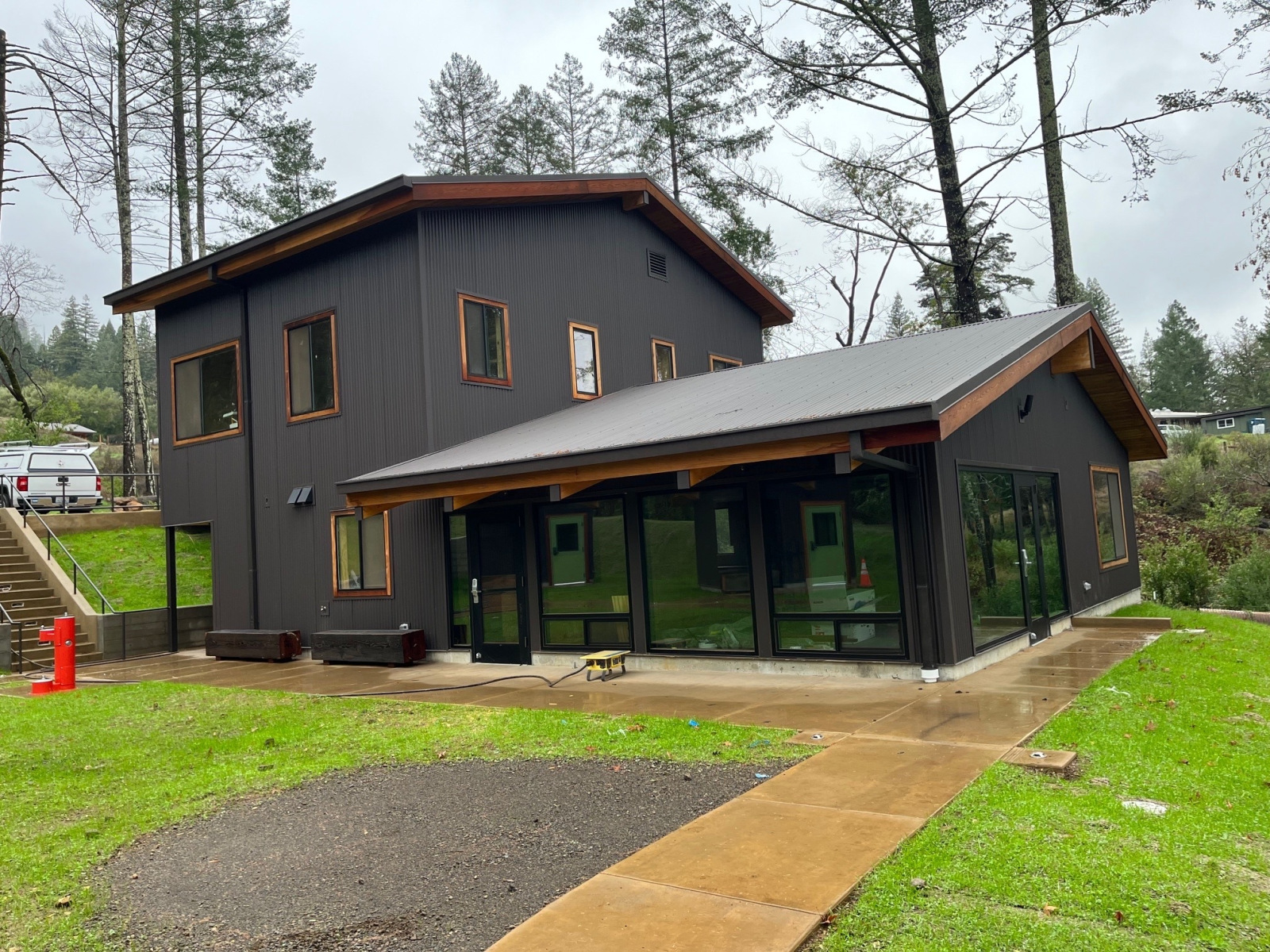 EHC Two Story Structure A large, two-story structure with lots of large windows and a freshly paved path leading up to it
