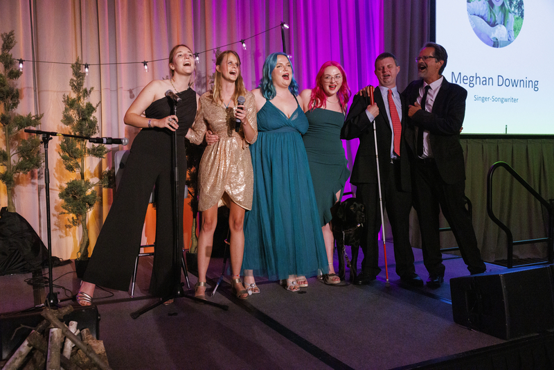 Gala 23 EHC Friends EHC staff and longtime friend and camper pose together on stage